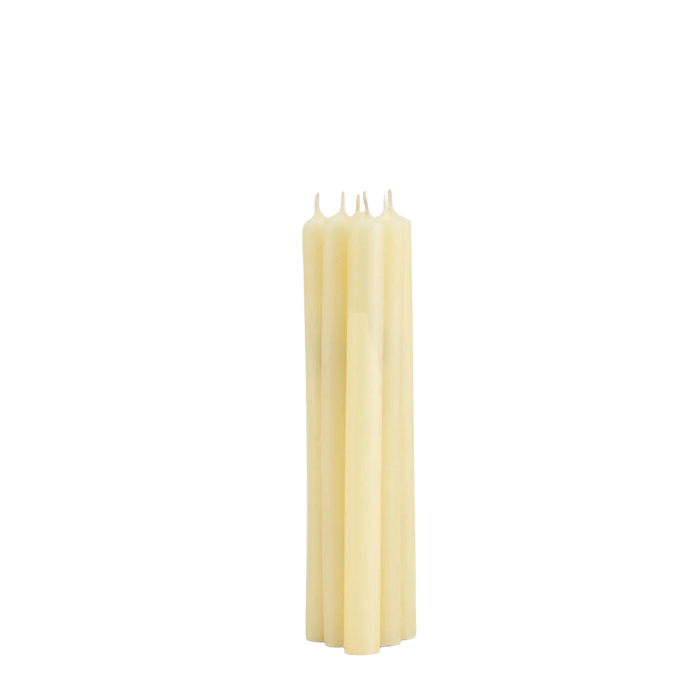 Four unbleached wax taper candles standing upright in a tight cluster against a plain white background.