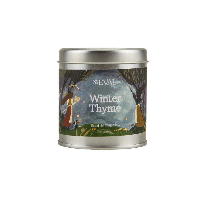 A silver metal tin candle with a colorful label reading 'S.EVAL Winter Thyme' and an illustration of a winter forest scene, centered on a plain white background.