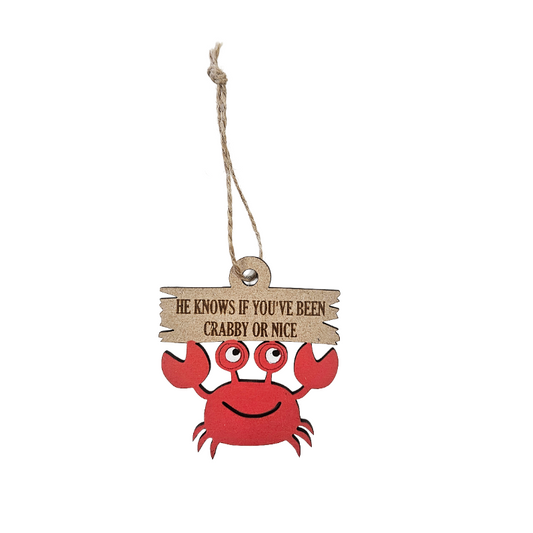 Red crab-shaped ornament with a wooden sign on a white background