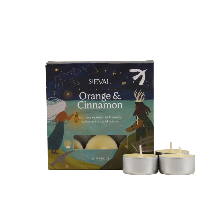 St Eval Orange & Cinnamon tea light candle box with three silver tea light candles in front on a white background.