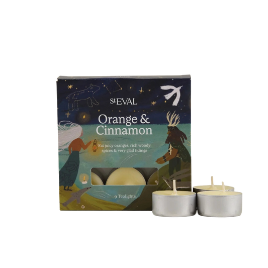 St Eval Orange & Cinnamon tea light candle box with three silver tea light candles in front on a white background.