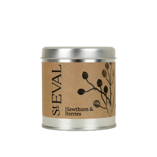 A St Eval Hawthorn & Berries candle in a round silver metal tin with a brown kraft paper label featuring black berry illustrations.