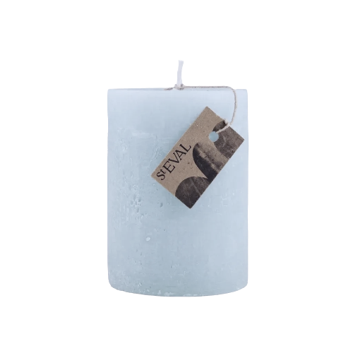 A light blue textured pillar candle with a hanging kraft paper tag that reads 'SEVAL', isolated on a white background.